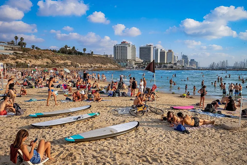 Tel Aviv’s beach with the city skyline behind it
